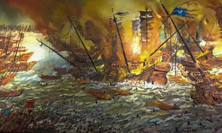 A modern painting or illustration of the 1288 Battle of Bạch Đằng — wooden spikes breaching the surface, war vessels clashing