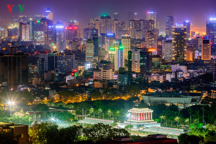 Modern commercial streets in Hanoi or Ho Chi Minh City — office buildings, retail storefronts, motorbikes