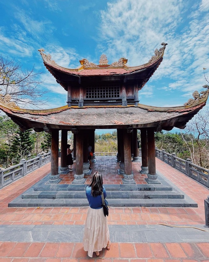 A Vietnamese Buddhist temple — a serene atmosphere, incense smoke, worshippers