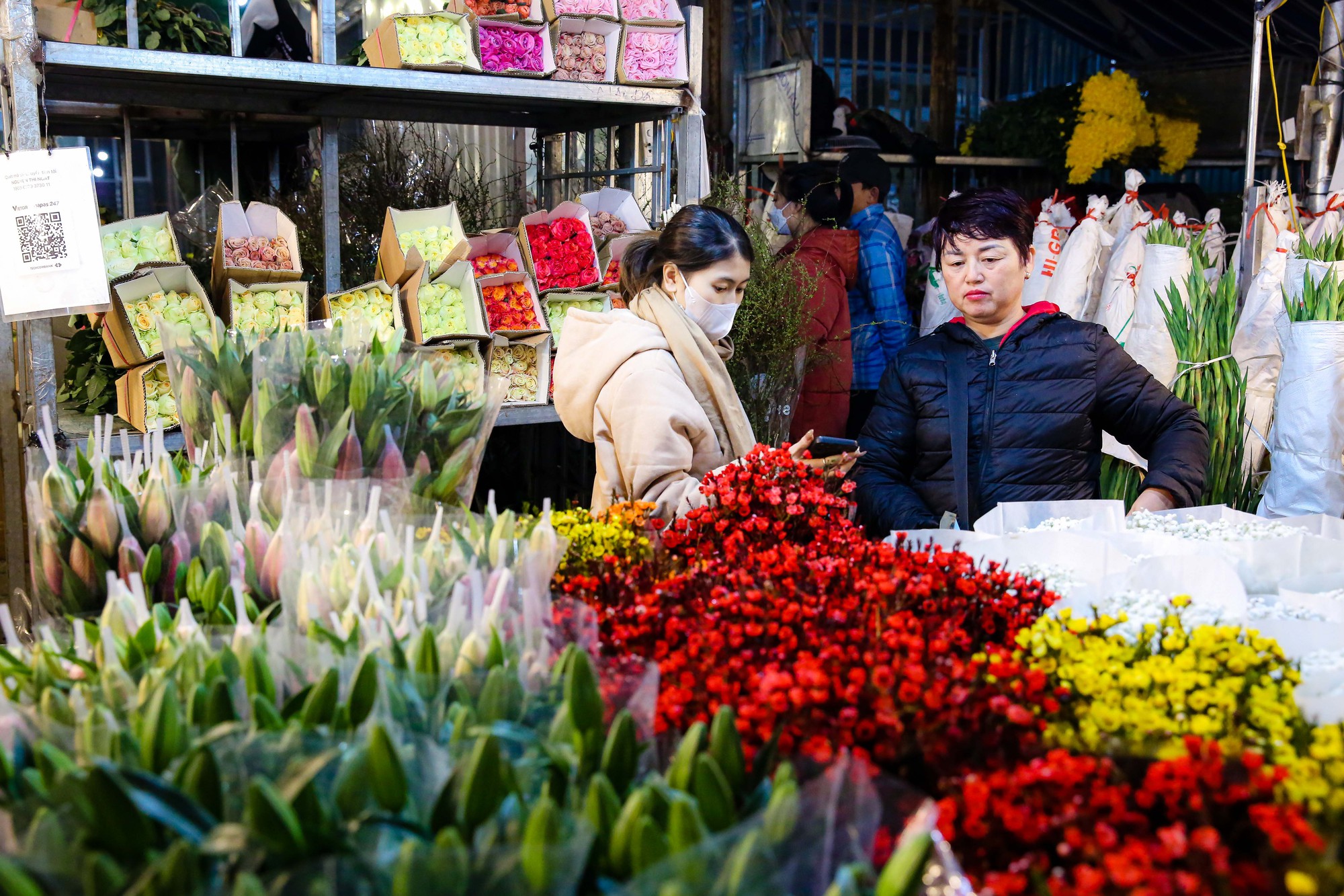 A bustling Tết flower market — peach blossoms in Hanoi or apricot blossoms in Saigon
