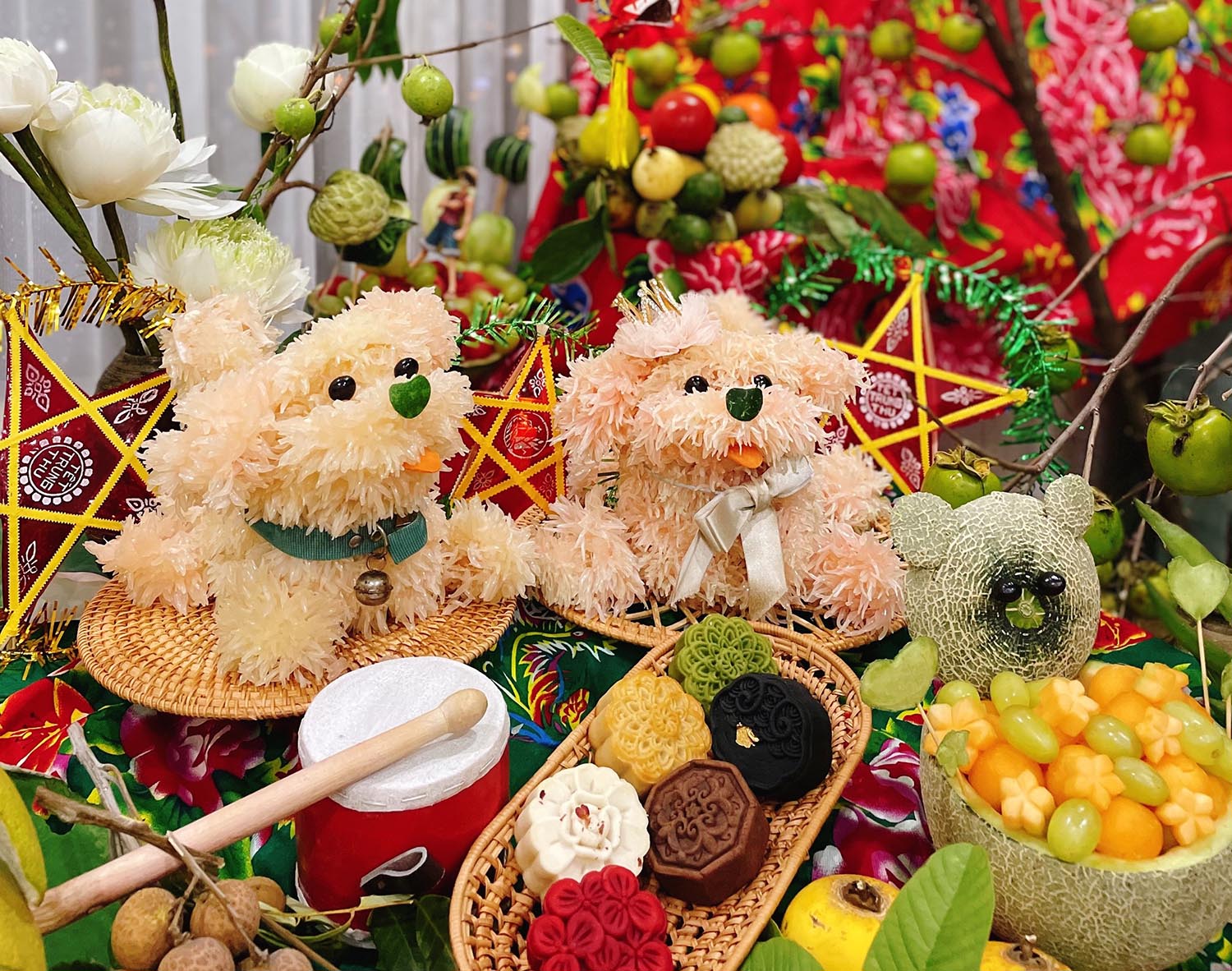 A Mid-Autumn feast (phá cỗ) — a tray of fruit, mooncakes, lanterns, and children gathered around
