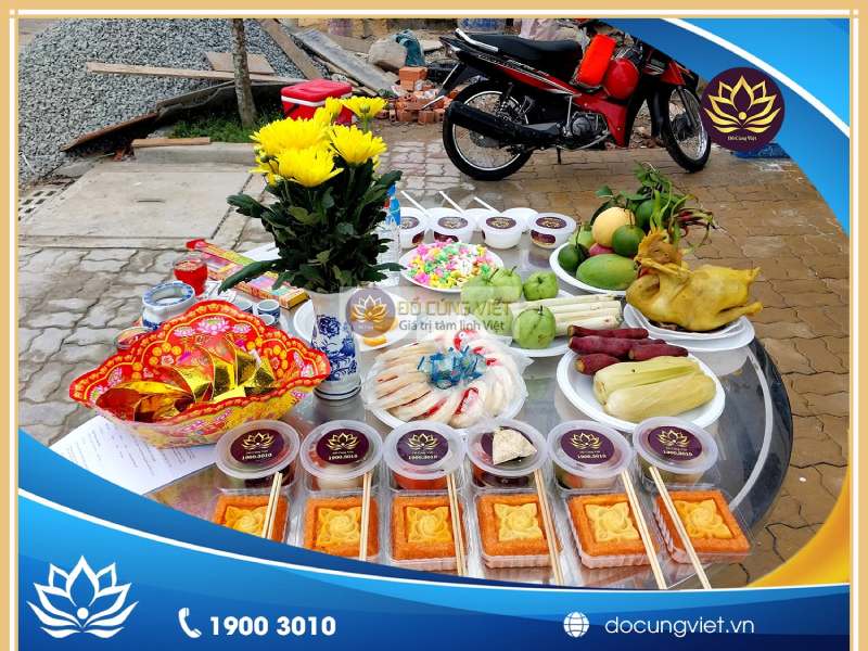 An outdoor offering for wandering spirits — an altar, incense smoke, people burning votive paper
