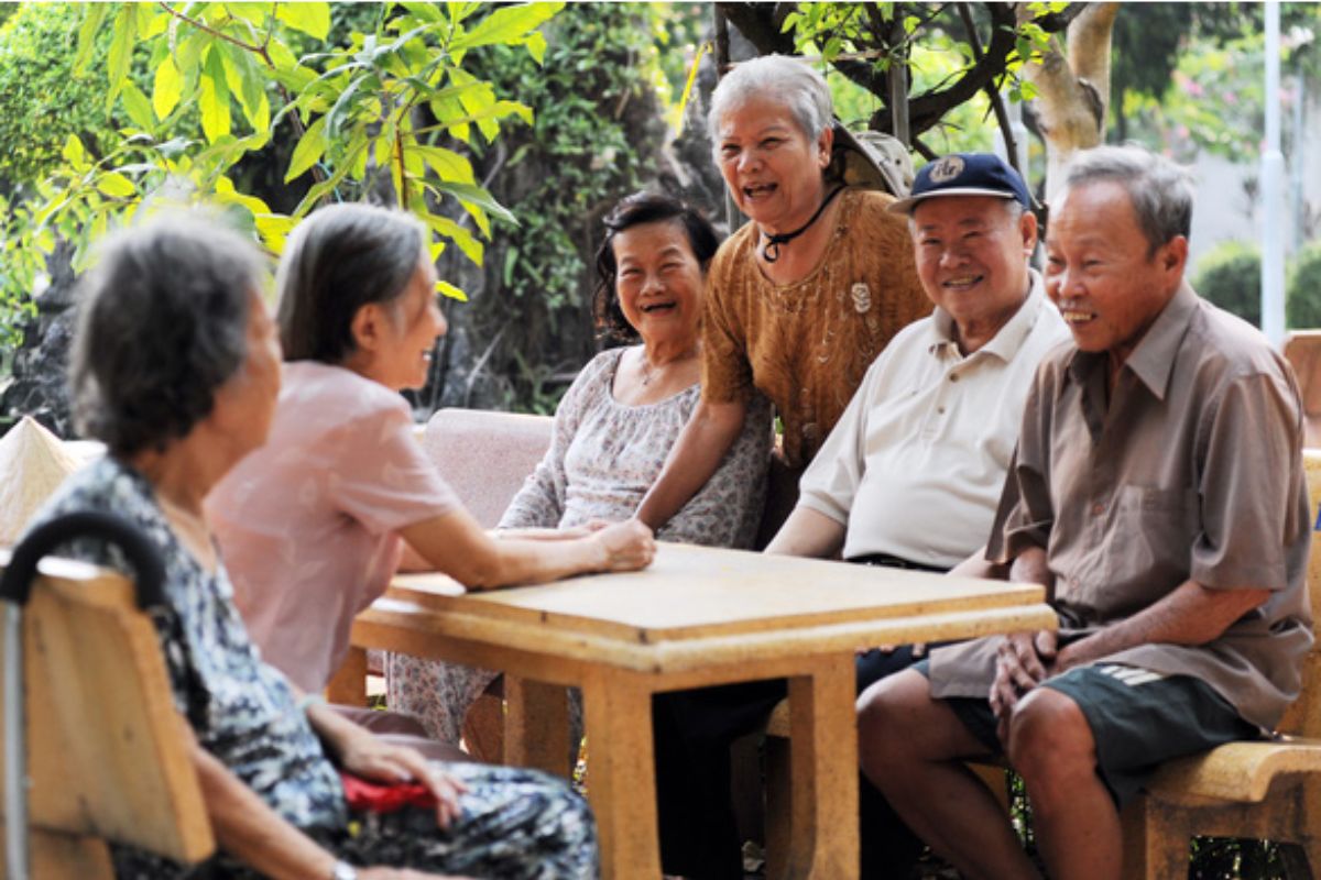 A young Vietnamese person speaking to an elder — displaying obvious respect