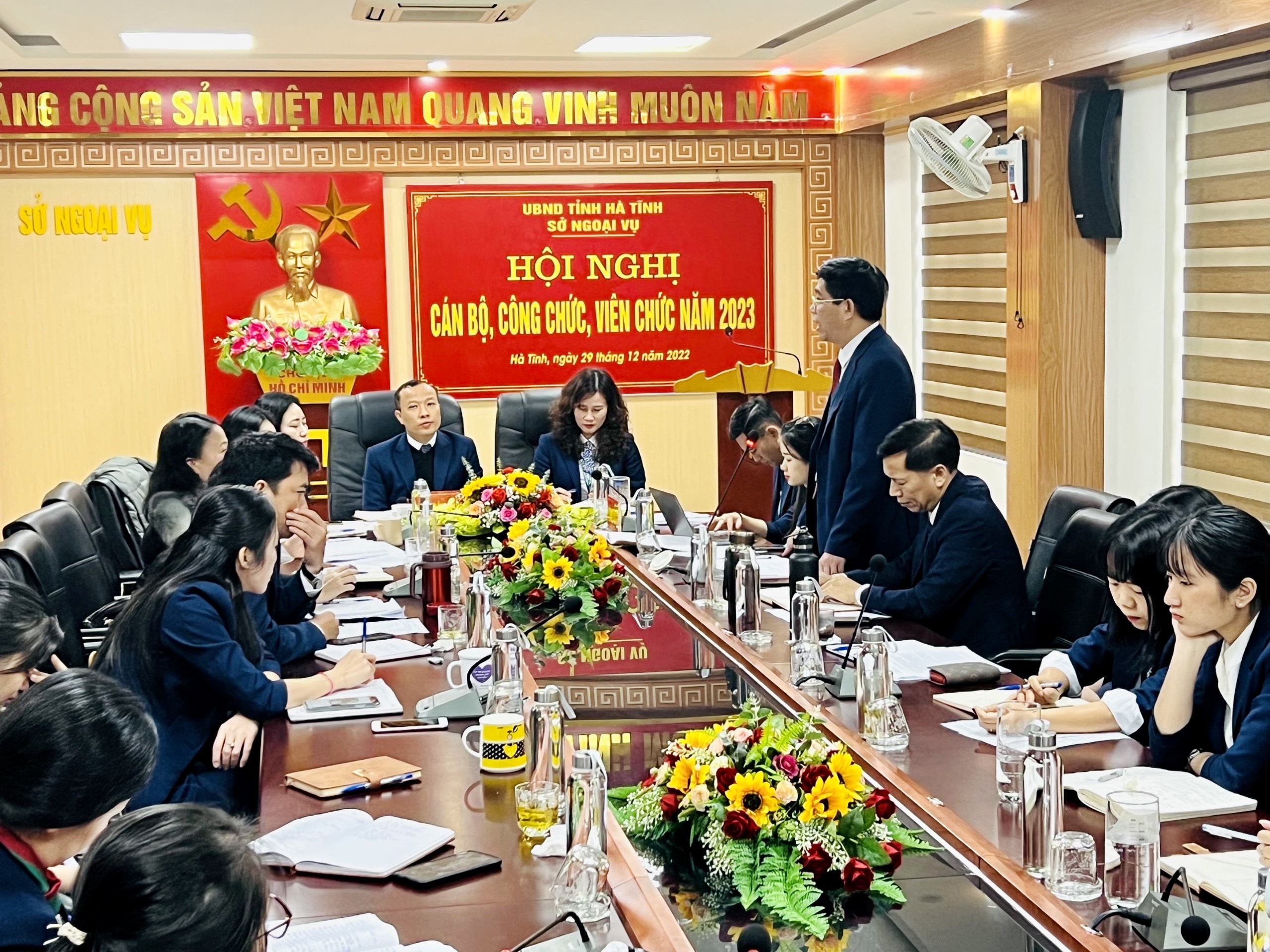 An elderly Vietnamese man sitting solemnly at a meeting table — exuding authority and prestige