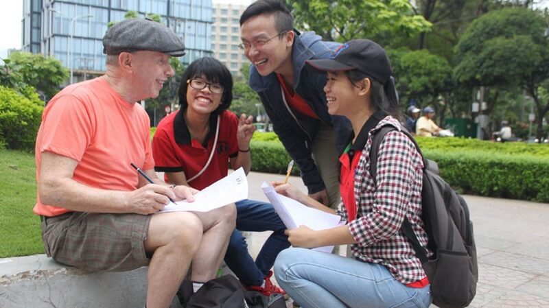 A foreigner and a Vietnamese person conversing — the Westerner looking slightly surprised
