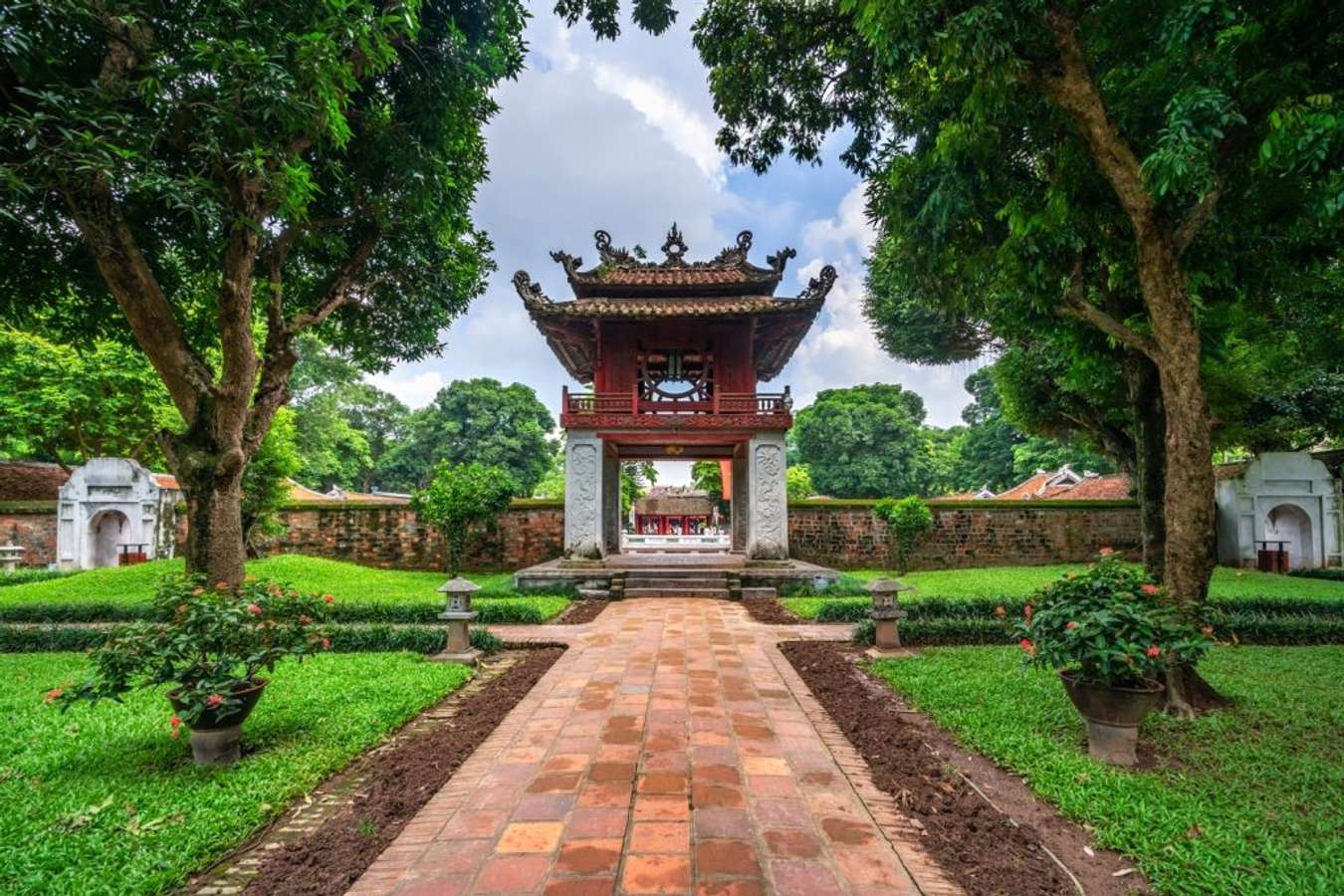 The Temple of Literature in Hanoi — ancient architecture, stone steles of scholars, students coming to pray