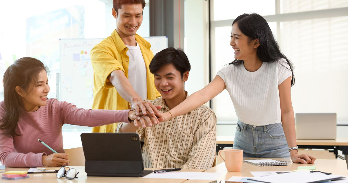 A group of Vietnamese people working together — team spirit, all facing the same goal