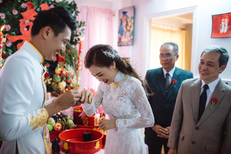 A Vietnamese son bowing deeply to his parents during his wedding ceremony — the most sacred moment