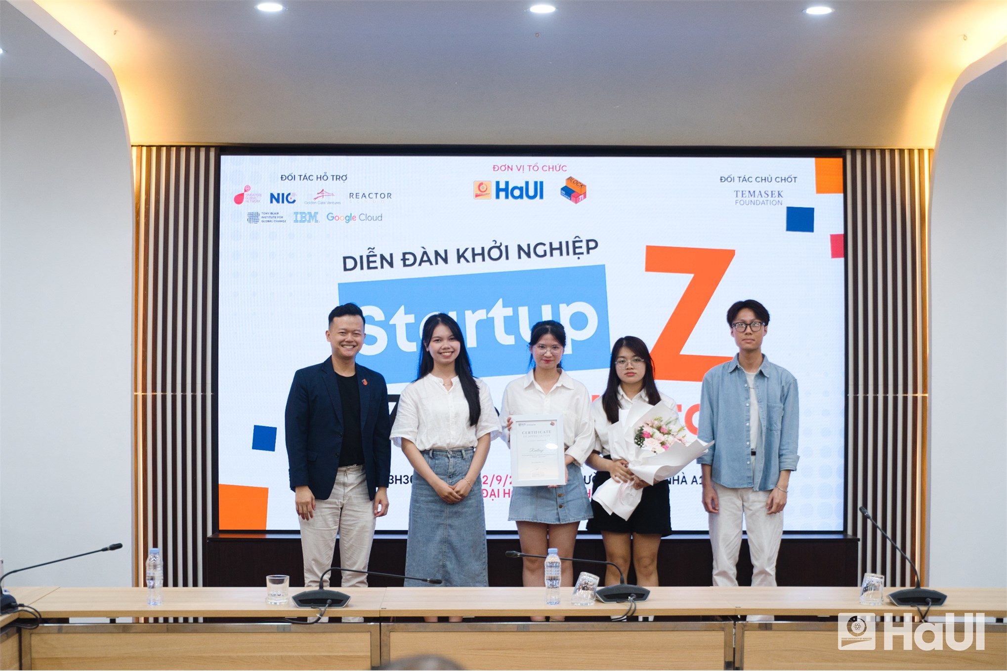 A young Vietnamese startup entrepreneur — a startup flag, modern workspace