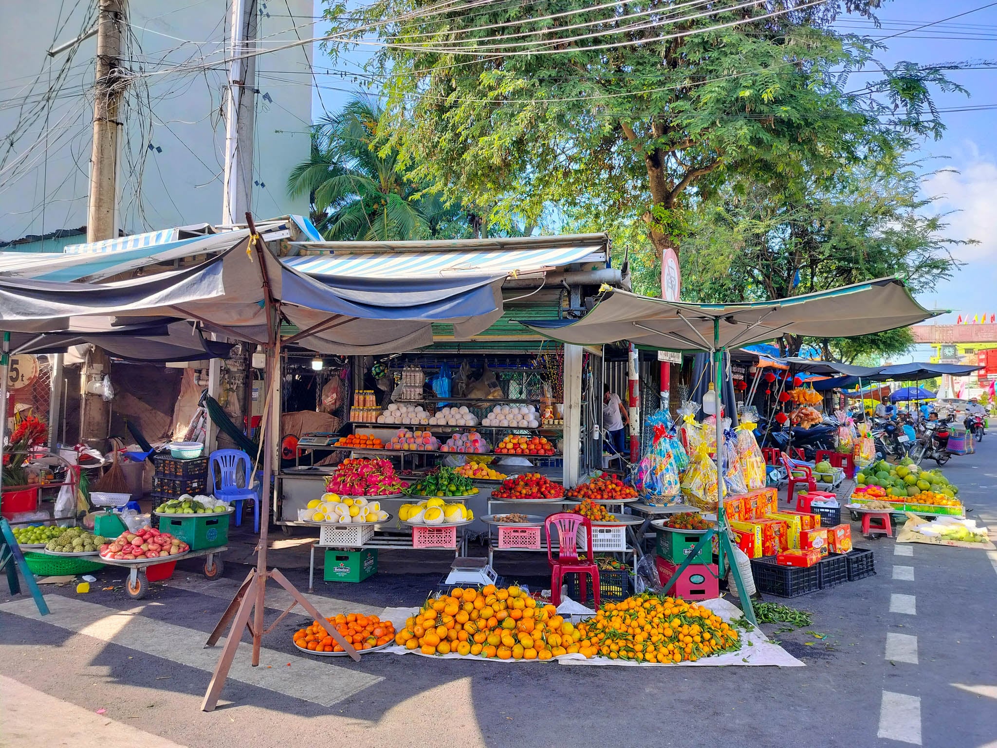 A Vietnamese market street where every single shop sells the exact same product — motorcycles, raincoats, plastics
