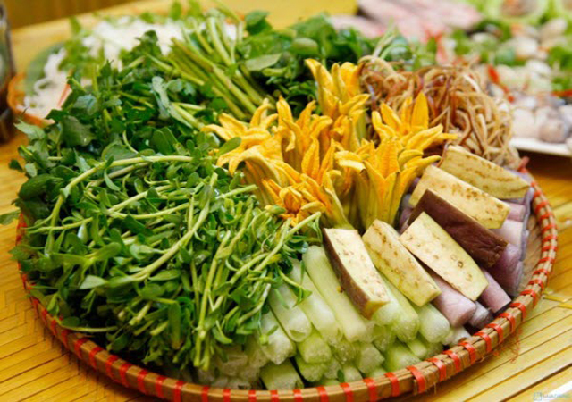 A massive plate of various fresh herbs for accompaniment — Thai basil, mint, perilla, Vietnamese balm, fish mint