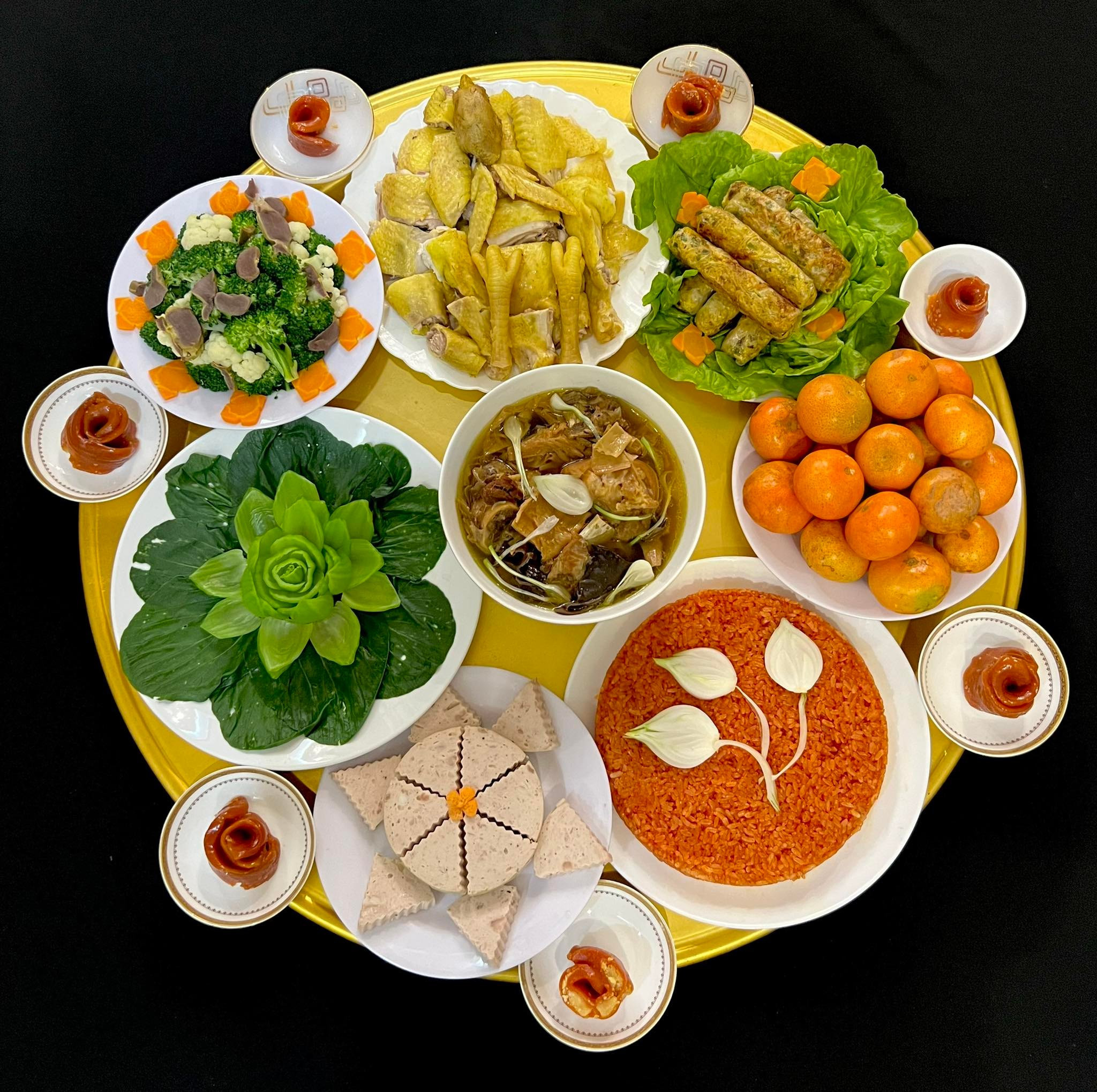 A sprawling Southern meal — sour soup, caramelized fish in a clay pot, massive platters of raw vegetables