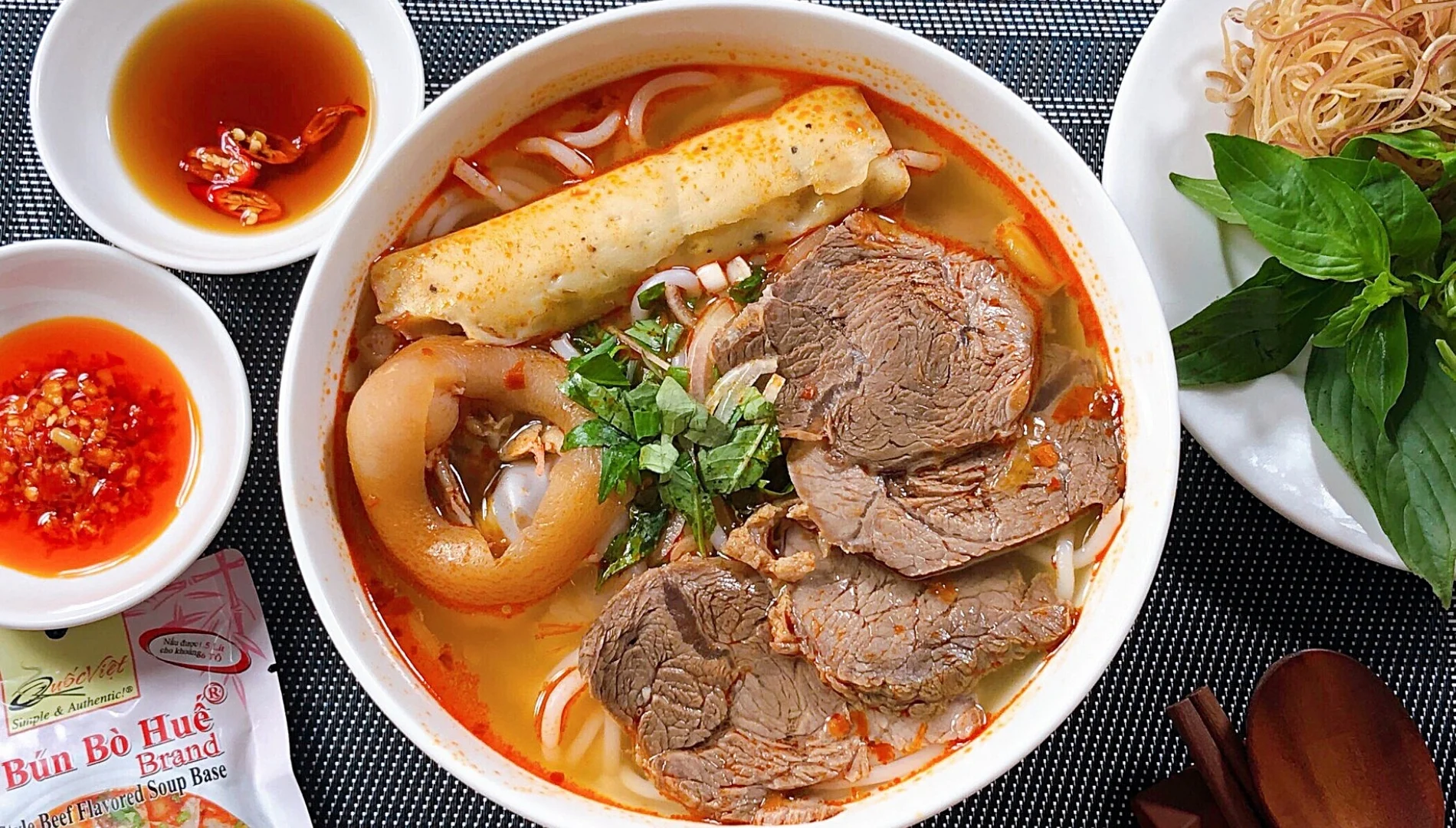 A Hanoian grimacing while tasting heavy fermented shrimp paste or spicy Hue noodles — a humorous expression