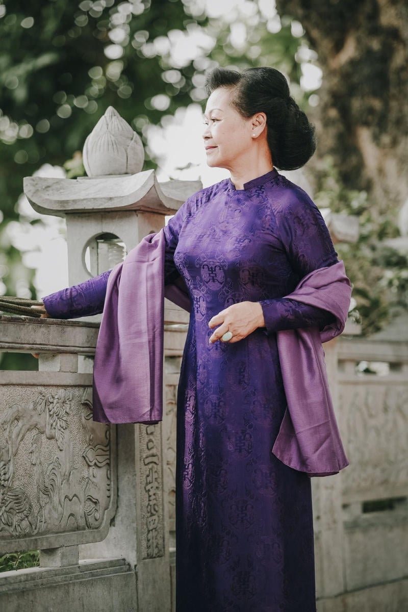 Hue women wearing purple Ao Dai — the signature color of Hue — walking to the pagoda to pray