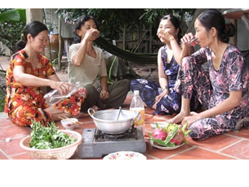 Western locals sitting drinking rice wine and eating under the shade of a tree — radiating absolute relaxation