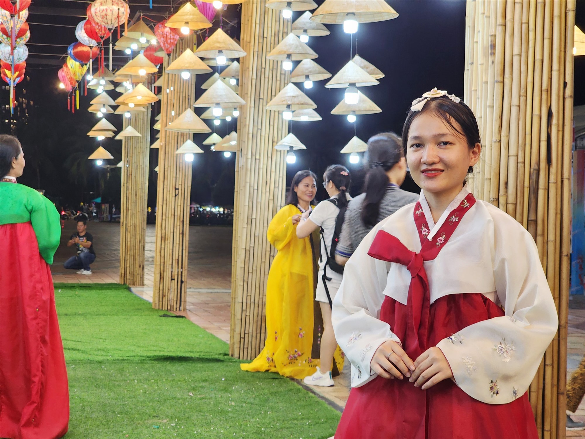 Vietnamese youth wearing Korean Hanbok while taking photographs at a traditional Vietnamese pagoda — a fascinating cultural mashup