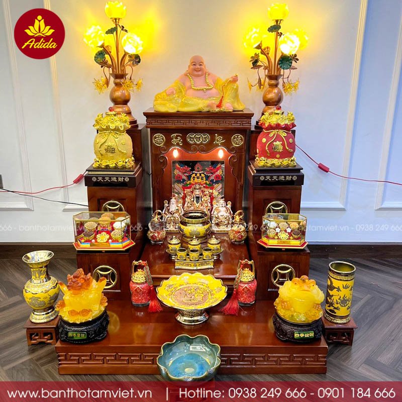 A shrine for the God of Wealth and Earth God inside a Vietnamese shop — two small statues, fruit, and incense